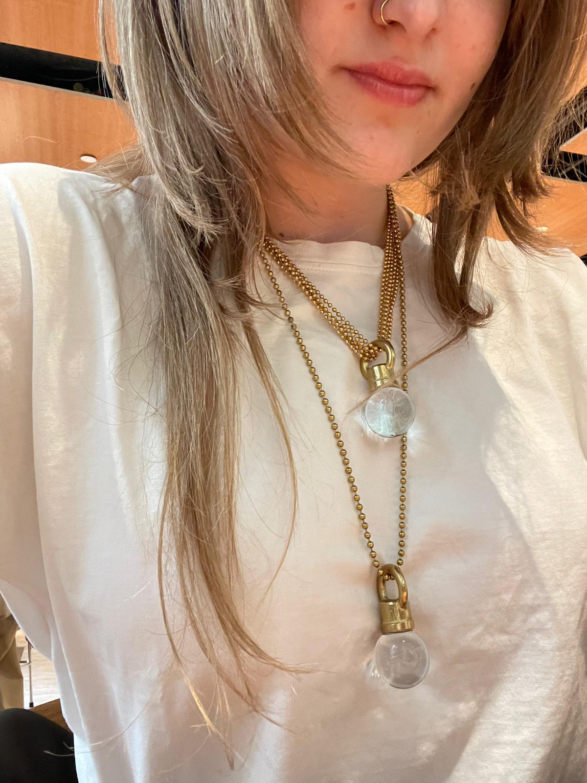 Classic KRT necklaces worn together on model in white t-shirt, showing layered lengths with Czech crystal orb pendants